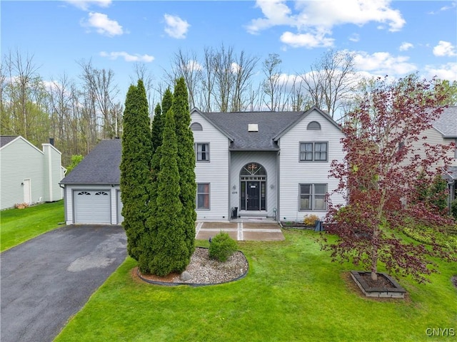 traditional-style home with asphalt driveway and a front lawn
