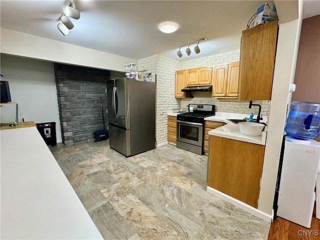 107 Birchwood Ln, Frankfort, NY 13340 - kitchen featuring under cabinet range hood, a sink, rail lighting, light countertops, and appliances with stainless steel finishes