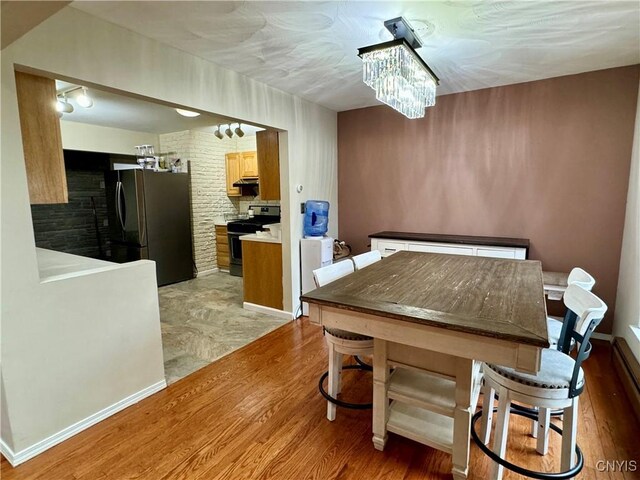 107 Birchwood Ln, Frankfort, NY 13340 - dining room featuring a notable chandelier and light wood-style floors