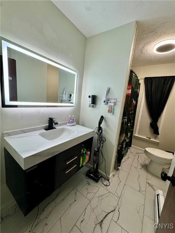 107 Birchwood Ln, Frankfort, NY 13340 - bathroom featuring a textured ceiling, toilet, marble finish floor, baseboards, and vanity