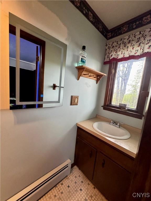 107 Birchwood Ln, Frankfort, NY 13340 - bathroom featuring vanity, tile patterned floors, and a baseboard heating unit