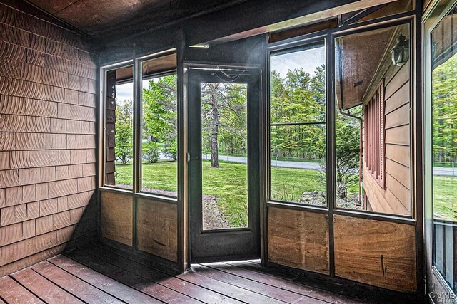 107 Birchwood Ln, Frankfort, NY 13340 - doorway with a wealth of natural light, hardwood / wood-style floors, and wooden walls