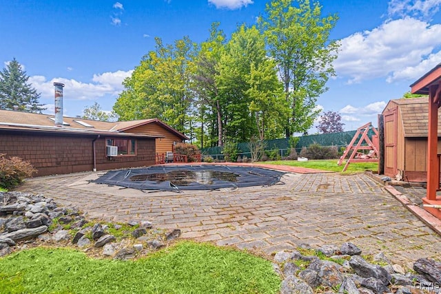 107 Birchwood Ln, Frankfort, NY 13340 - view of pool featuring a patio area, an outbuilding, a fenced backyard, and a storage unit