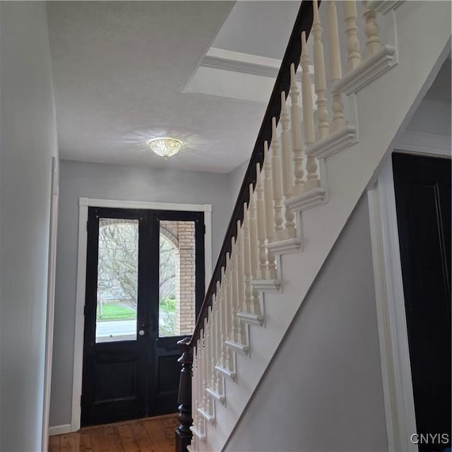 entryway featuring stairway, french doors, and hardwood / wood-style floors