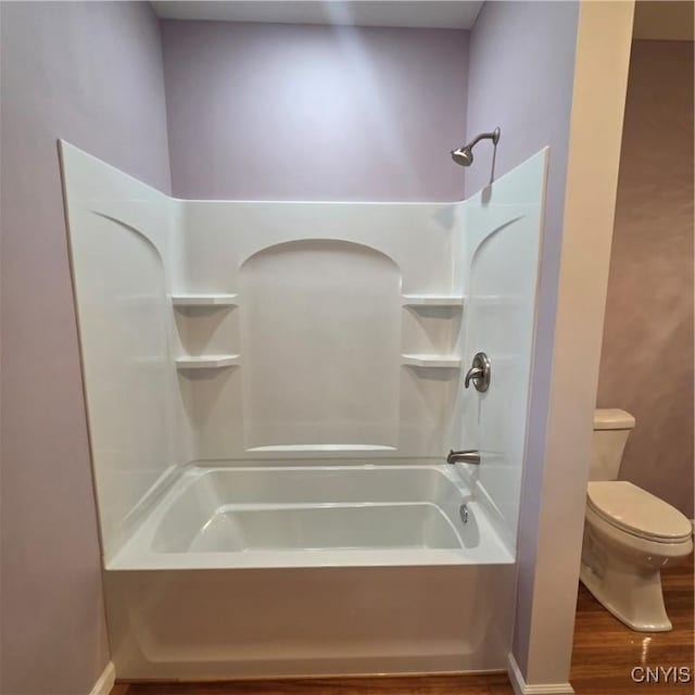 bathroom featuring shower / bath combination, toilet, and wood finished floors