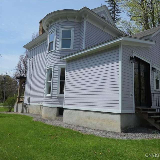 view of home's exterior with a lawn and a chimney