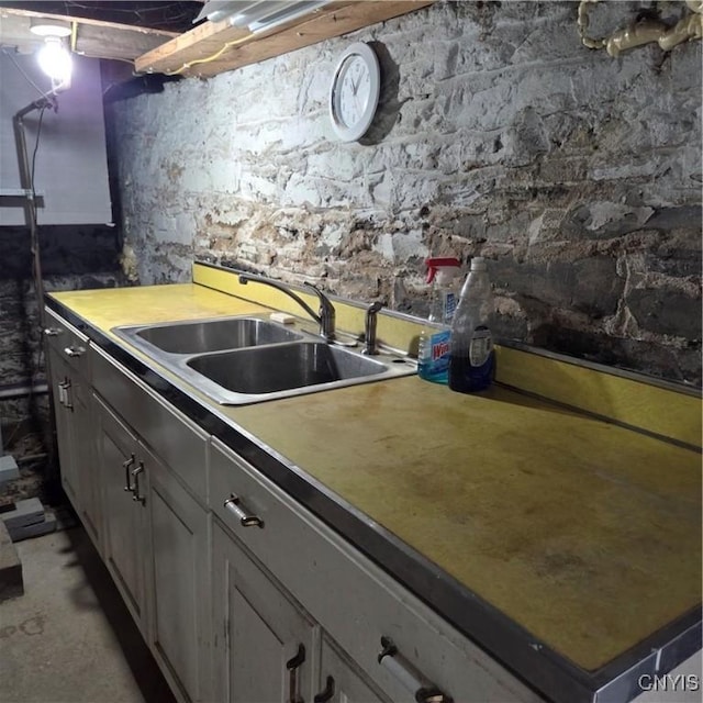 kitchen with a sink and concrete flooring