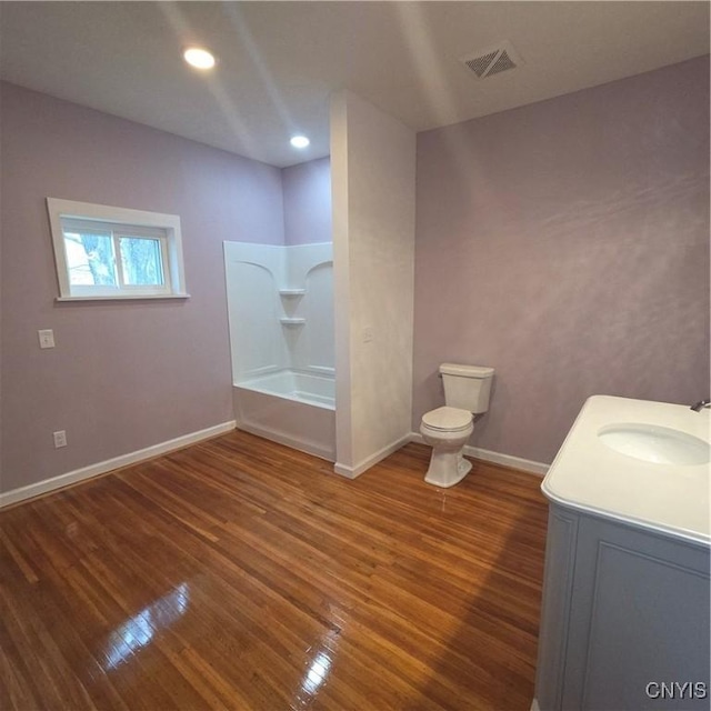 full bathroom with toilet, wood finished floors, visible vents, baseboards, and vanity