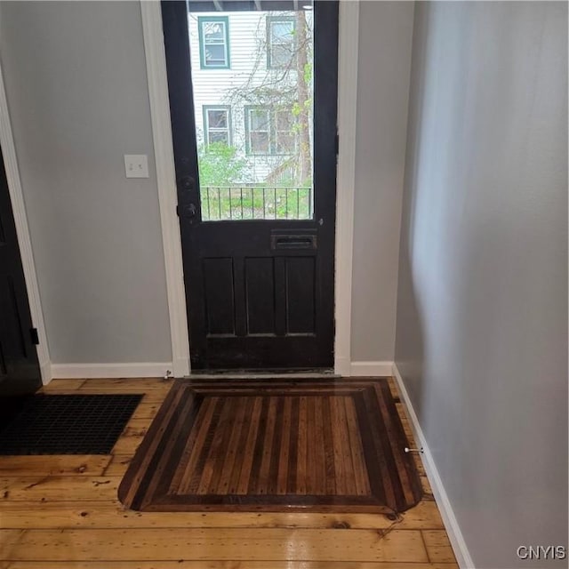 entryway with baseboards and wood-type flooring