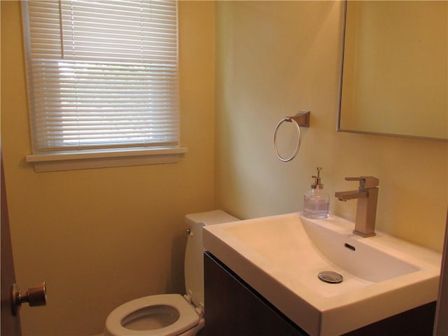 bathroom with toilet and vanity