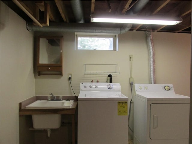 laundry room with a sink, laundry area, and independent washer and dryer