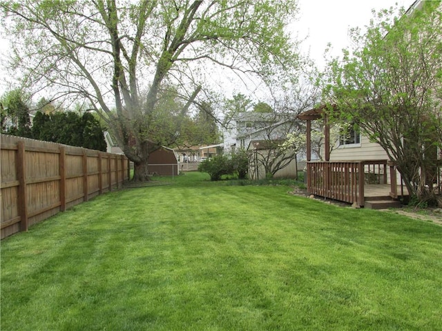view of yard with fence and a wooden deck