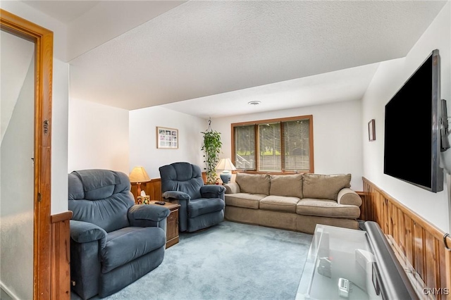 living room featuring light colored carpet and wainscoting