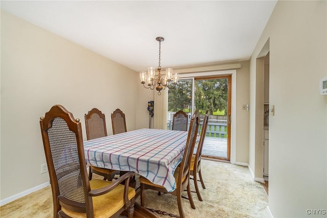 dining room with light colored carpet, an inviting chandelier, and baseboards