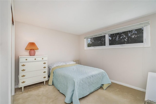 carpeted bedroom featuring baseboards