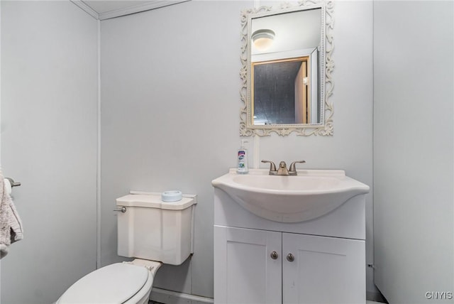 half bath featuring toilet and vanity