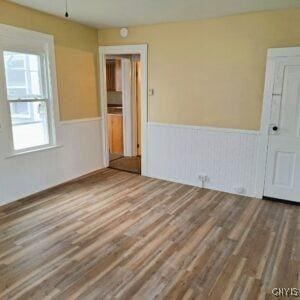 1011 Irving St, Olean-City, NY 14760 - spare room with wainscoting and wood finished floors