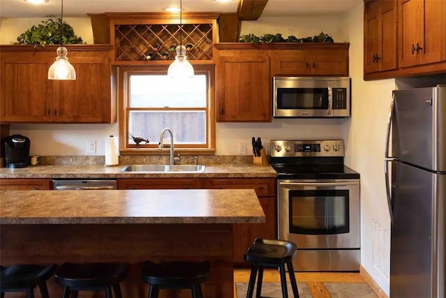 7136 Maples Rd, Mansfield, NY 14755 - kitchen with a sink, a kitchen breakfast bar, brown cabinets, light countertops, and appliances with stainless steel finishes