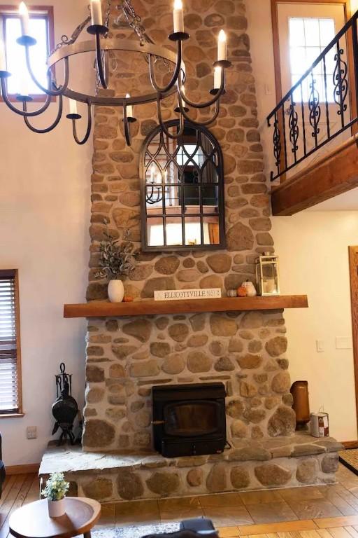 7136 Maples Rd, Mansfield, NY 14755 - bar featuring baseboards, a wood stove, a high ceiling, and wood finished floors