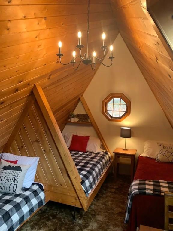 7136 Maples Rd, Mansfield, NY 14755 - bedroom featuring a chandelier and lofted ceiling