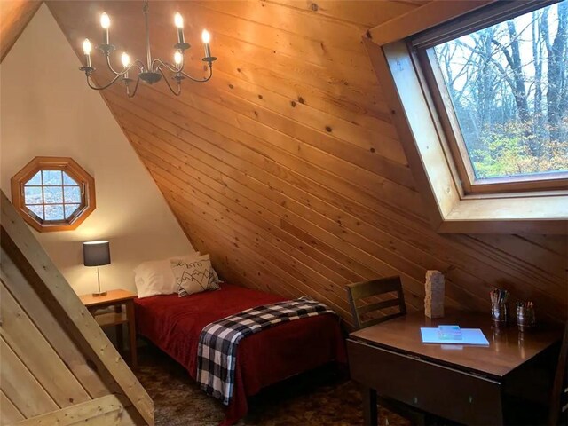 7136 Maples Rd, Mansfield, NY 14755 - bedroom with lofted ceiling and a notable chandelier