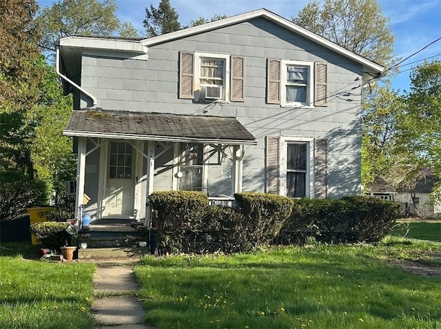 view of front of home with a front lawn and cooling unit