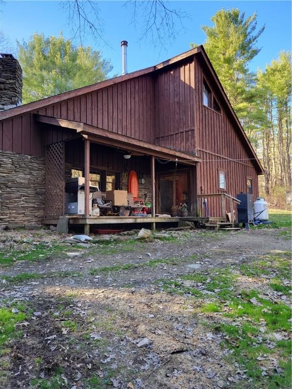 607 Kilkenny Rd, Unadilla, NY 13849 - back of property with a chimney, stone siding, and board and batten siding
