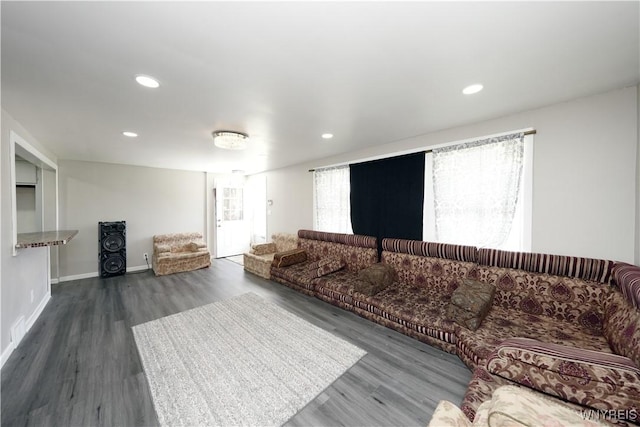 living room with baseboards, recessed lighting, and wood finished floors