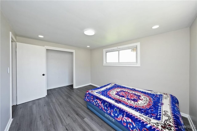 bedroom with baseboards, recessed lighting, and wood finished floors