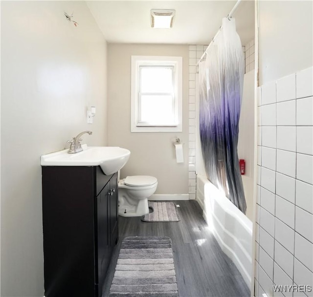 full bathroom with toilet, wood finished floors, vanity, shower / tub combo with curtain, and visible vents