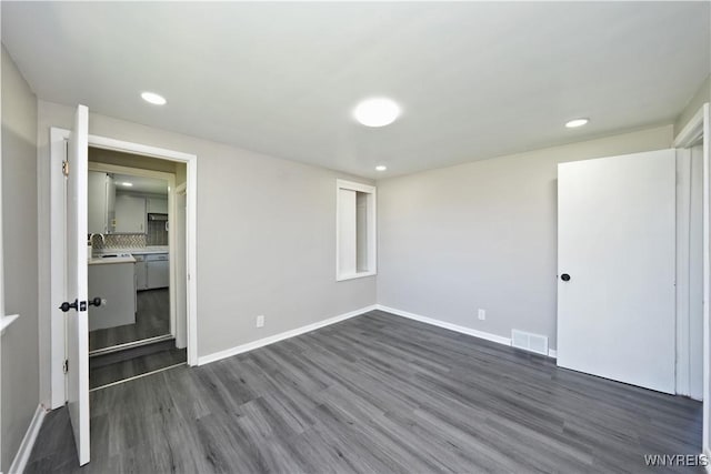 unfurnished bedroom with recessed lighting, baseboards, visible vents, and dark wood finished floors