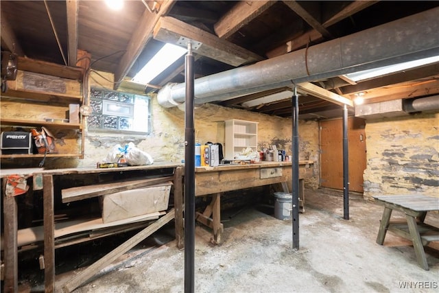 unfinished below grade area with a workshop area
