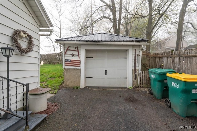 detached garage with fence and driveway