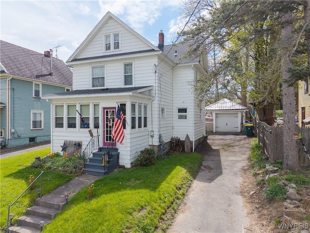 view of front of property with asphalt driveway, an outdoor structure, a detached garage, entry steps, and a chimney