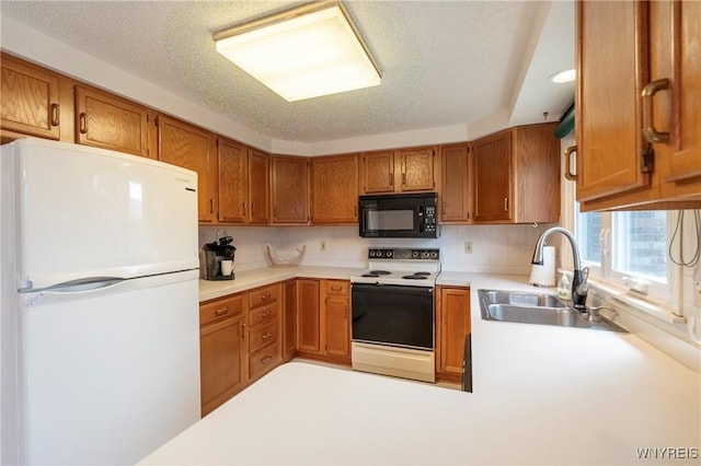 kitchen with white appliances, a sink, light countertops, brown cabinets, and recessed lighting