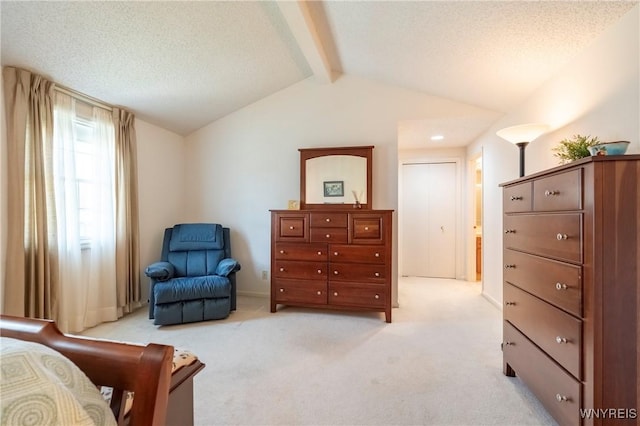 bedroom featuring light carpet, a textured ceiling, and baseboards