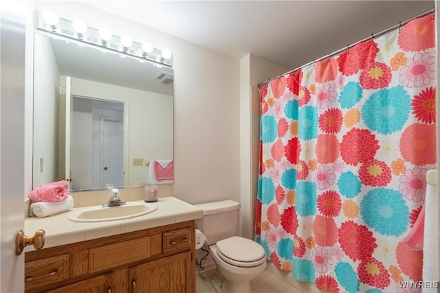 bathroom with toilet, vanity, tile patterned flooring, and a shower with curtain