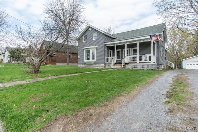 108 Mechanic St, Antwerp, NY 13608 - view of front facade featuring covered porch, roof with shingles, an outdoor structure, a front yard, and gravel driveway