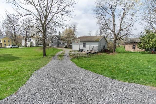 108 Mechanic St, Antwerp, NY 13608 - view of front facade featuring gravel driveway, a residential view, and a front lawn