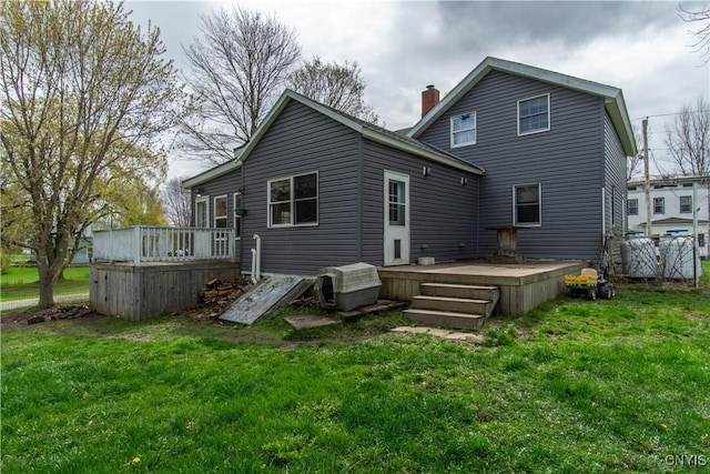 108 Mechanic St, Antwerp, NY 13608 - rear view of property with a yard, a chimney, and a wooden deck