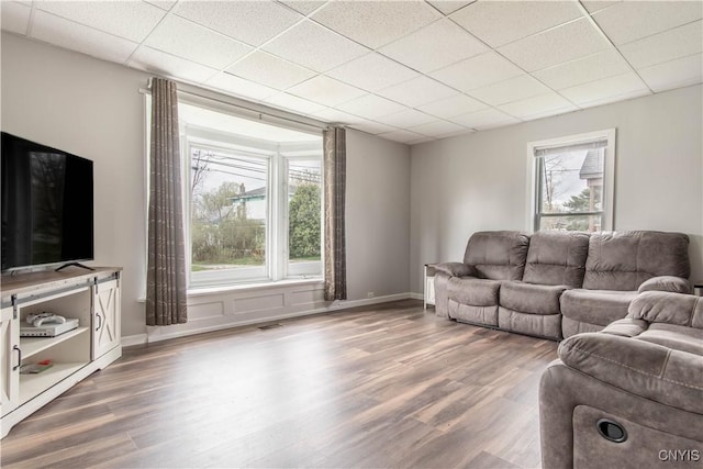 108 Mechanic St, Antwerp, NY 13608 - living room featuring a paneled ceiling, a wealth of natural light, and wood finished floors
