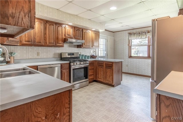 108 Mechanic St, Antwerp, NY 13608 - kitchen with brown cabinets, a peninsula, appliances with stainless steel finishes, and under cabinet range hood