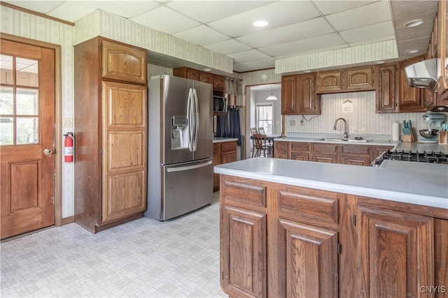 108 Mechanic St, Antwerp, NY 13608 - kitchen with a sink, wallpapered walls, stainless steel appliances, range hood, and light floors