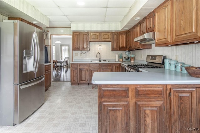 108 Mechanic St, Antwerp, NY 13608 - kitchen featuring a sink, a peninsula, stainless steel appliances, light floors, and under cabinet range hood
