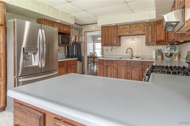 108 Mechanic St, Antwerp, NY 13608 - kitchen with a sink, a paneled ceiling, ventilation hood, light countertops, and appliances with stainless steel finishes