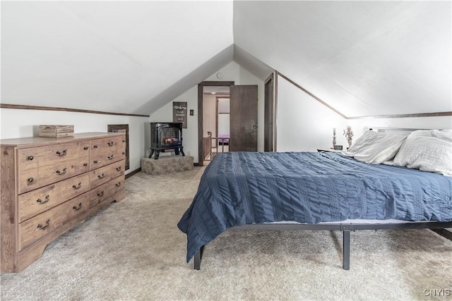 108 Mechanic St, Antwerp, NY 13608 - bedroom featuring a wood stove, lofted ceiling, and light colored carpet