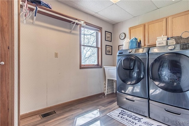 108 Mechanic St, Antwerp, NY 13608 - clothes washing area with baseboards, washer and dryer, visible vents, wood finished floors, and cabinet space