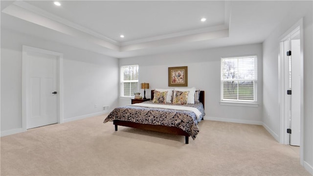bedroom with a tray ceiling, carpet floors, baseboards, and recessed lighting