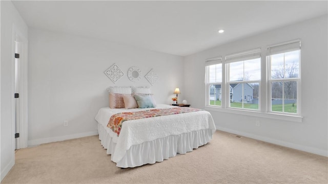 bedroom featuring baseboards, light carpet, and recessed lighting