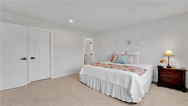 bedroom featuring light carpet, baseboards, and recessed lighting